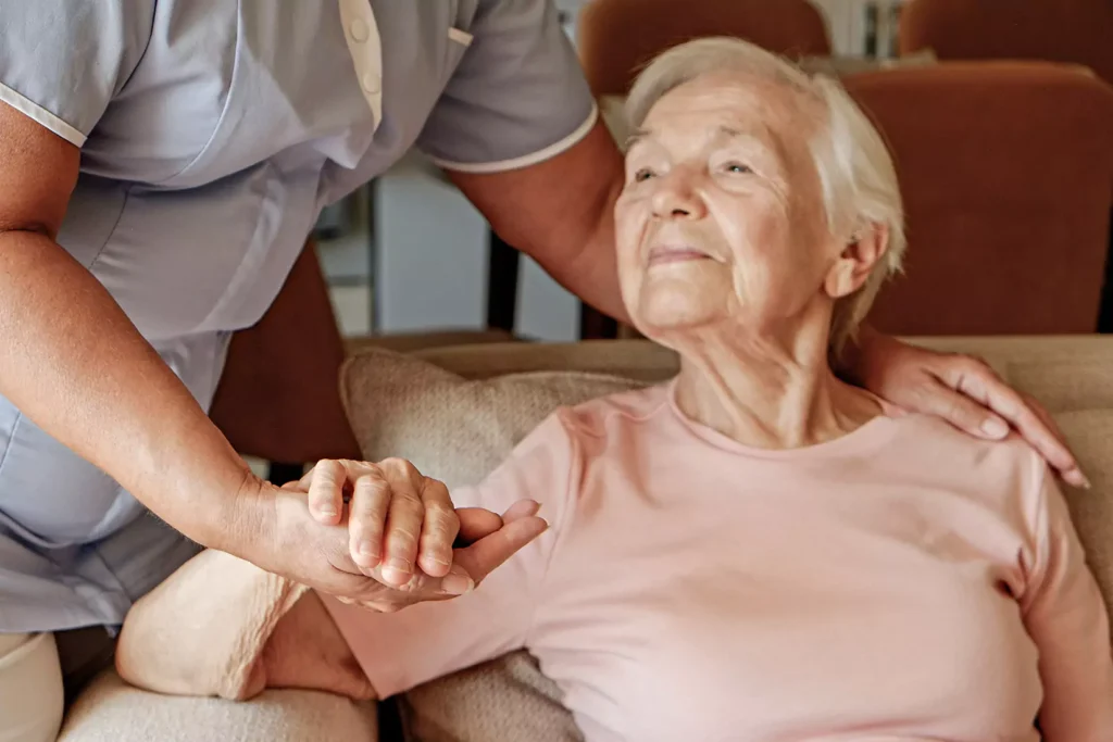 Elderly woman being cared for in home by nurse